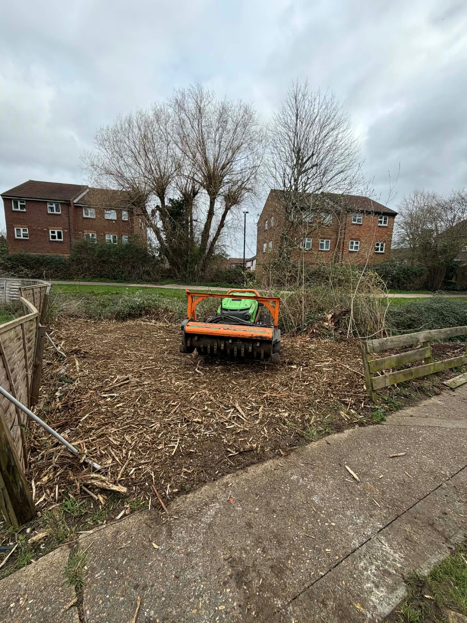 Robo flail clearing dense vegetation on rough ground