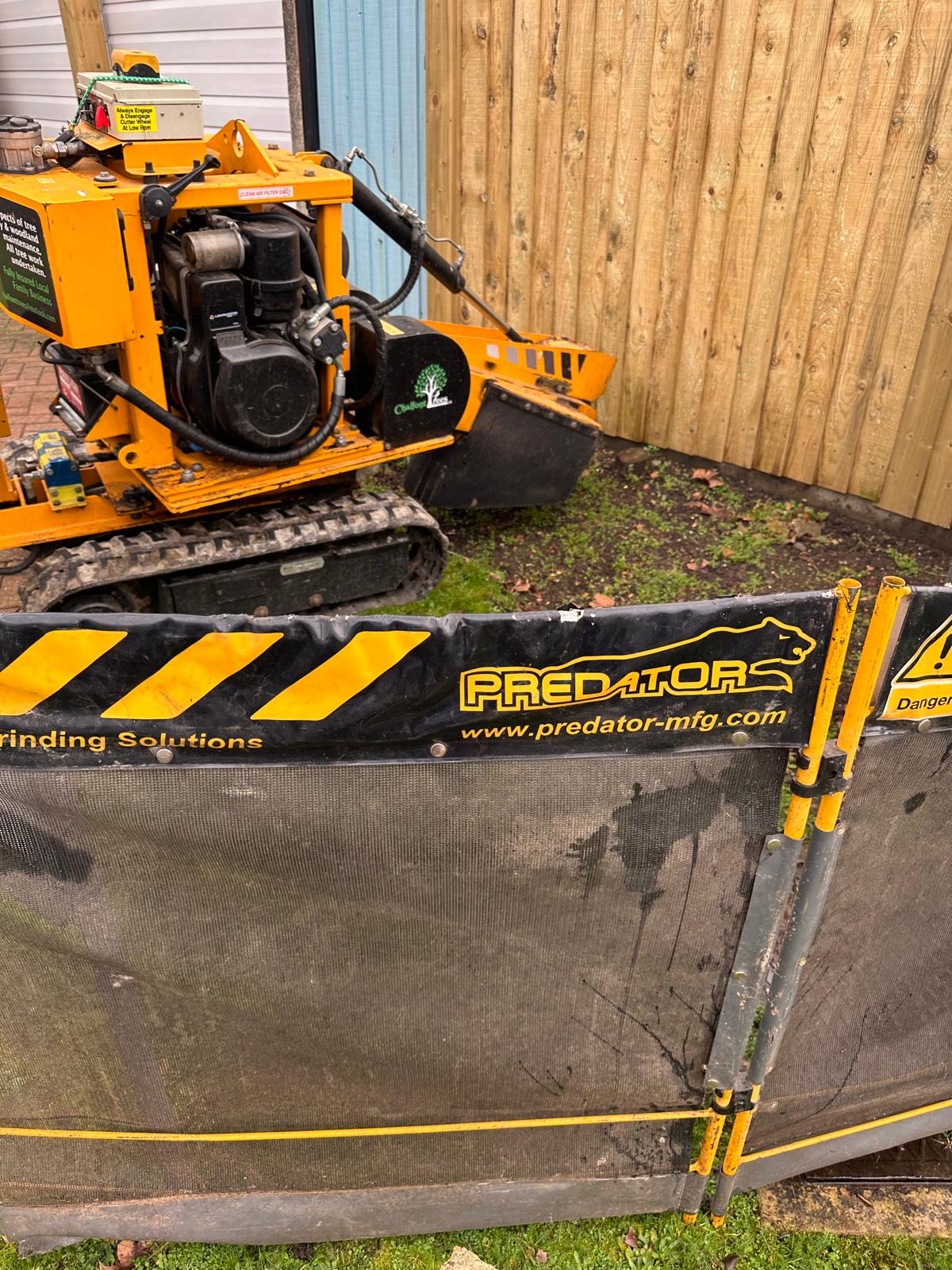 Stump grinder with protective barrier